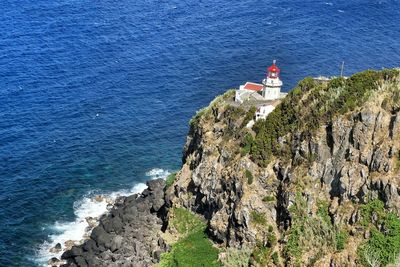 High angle view of cliff by sea against sky