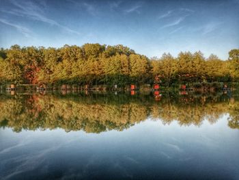Reflection of trees in lake against sky