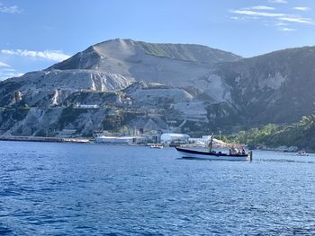 Scenic view of sea and mountains against sky