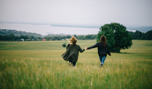 Rear view of women on field