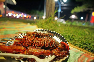 Close-up of food served on table at night