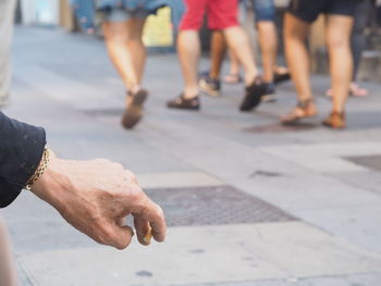 Cropped hand on person holding cigarette