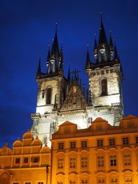 Low angle view of illuminated building against sky