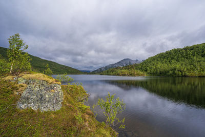 Scenic view of lake and mountains against sky