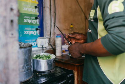 Midsection of man preparing food in kitchen