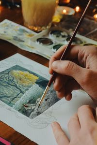 Close-up of hand painting watercolor