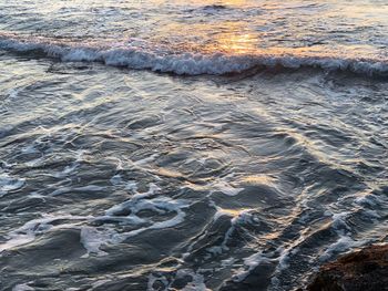 High angle view of waves rushing towards shore