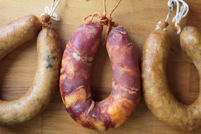 Portuguese smoked sausages, alheira and chorizo on wooden board