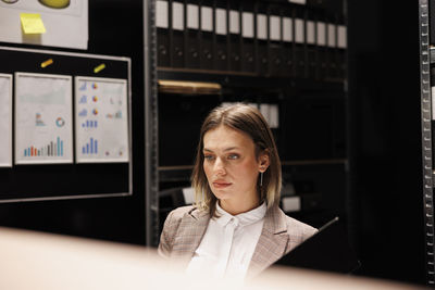 Portrait of young businesswoman standing in office