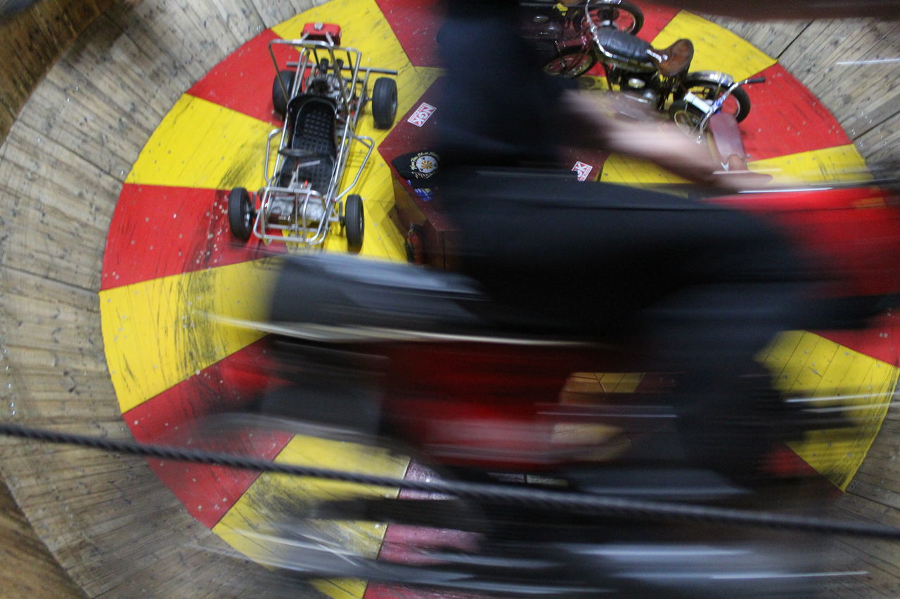 BLURRED MOTION OF PEOPLE RIDING MOTORCYCLE ON ROAD