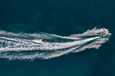 Aerial view of people jet boating in sea