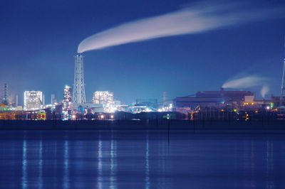 Illuminated buildings against sky at night