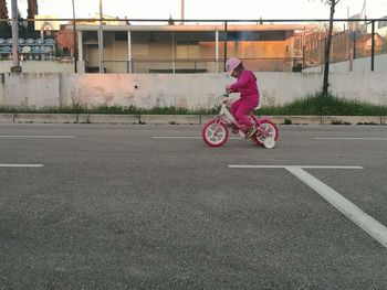 Side view of man riding bicycle on road