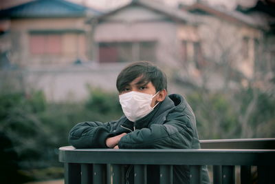 Portrait of man sitting outdoors in the new normal