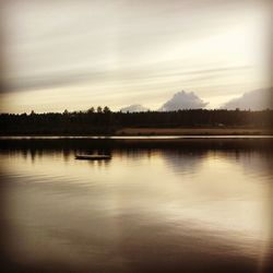 Scenic view of lake at sunset