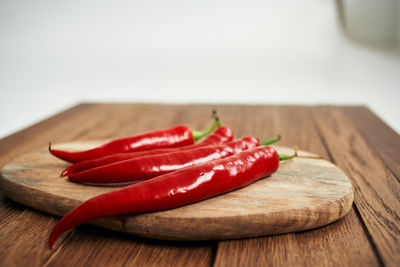 Close-up of red chili peppers on table