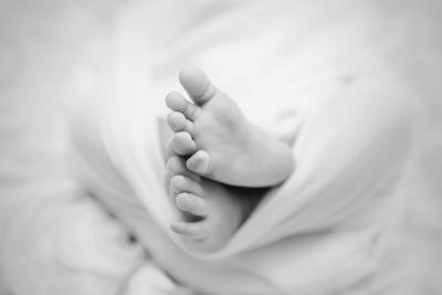 Close-up of baby feet on bed