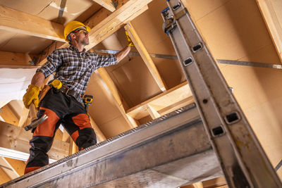 Low angle view of man working at construction site