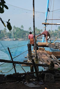 Fishing boats in water against clear sky