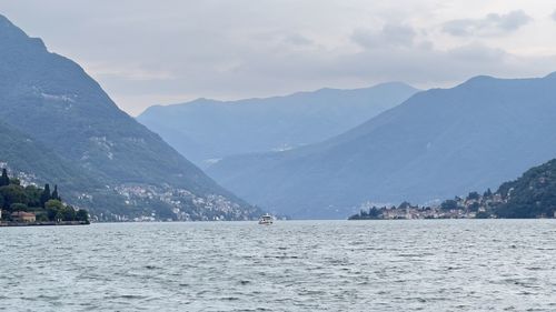 Scenic view of sea and mountains against sky