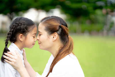 Portrait of mother and daughter outdoors