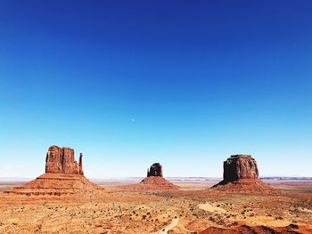 Rock formations in desert against blue sky