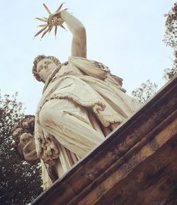 Low angle view of statue against sky