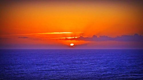 Scenic view of sea against orange sky