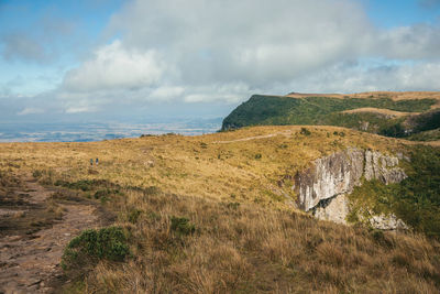 Dirt trail going down through rocky cliff in the fortaleza canyon near cambara do sul. brazil.