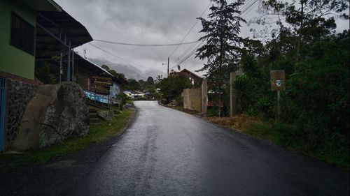 Empty road along buildings