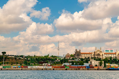 Panoramic view of river by buildings against sky