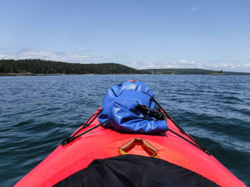 Kayak in sea against blue sky