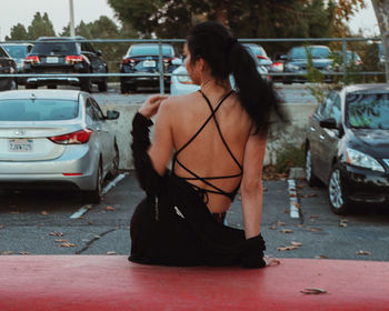 Woman with umbrella on street in city