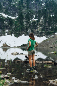 Hiker admiring waterfalls at the mountain lake in washington