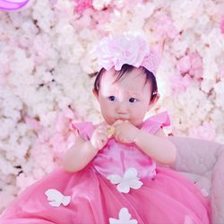 Portrait of cute baby girl with pink cherry blossom