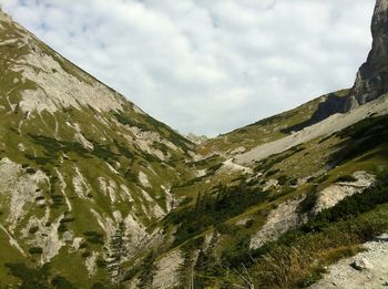 Scenic view of mountains against cloudy sky