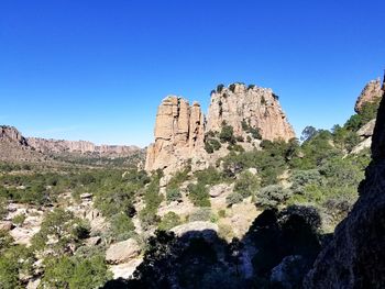 Scenic view of mountains against clear blue sky