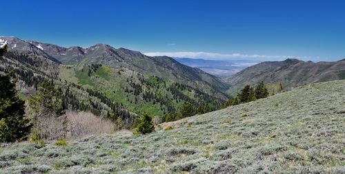 Scenic view of mountains against blue sky