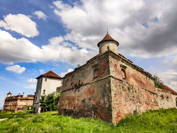 View of old building against cloudy sky