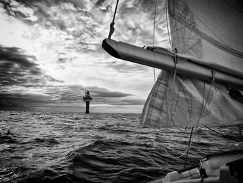 Man sailing in sea against sky