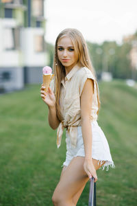 Woman eats sweet ice cream outdoor in park