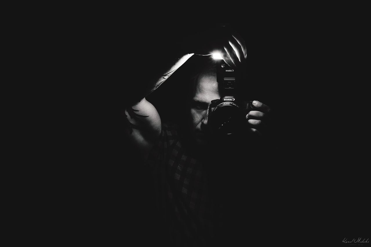 dark, side view, holding, person, black background, darkness, young adult, darkroom, human finger, studio shot