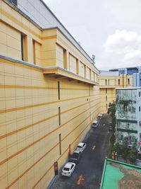 Road amidst buildings in city against sky