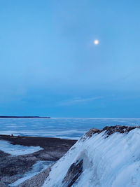 Scenic view of sea against sky during winter