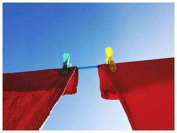 Red dish cloths drying on a washing line...
