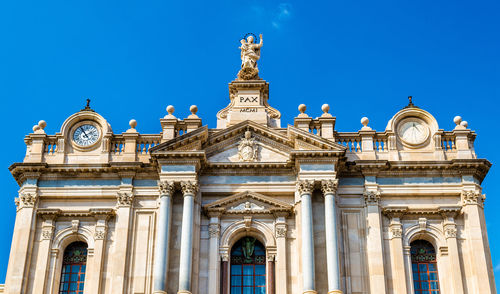 Low angle view of historical building against blue sky