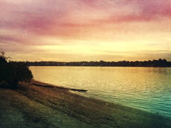 Scenic view of lake against cloudy sky