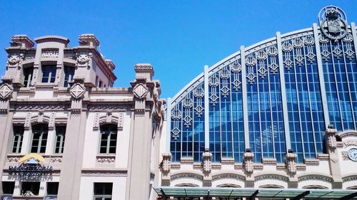 Low angle view of buildings against blue sky