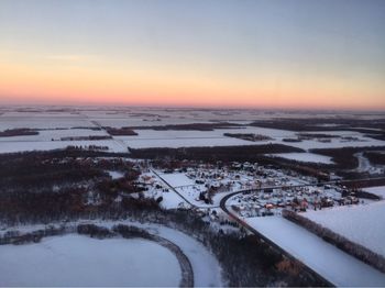 Scenic view of snow covered landscape against sky during sunset