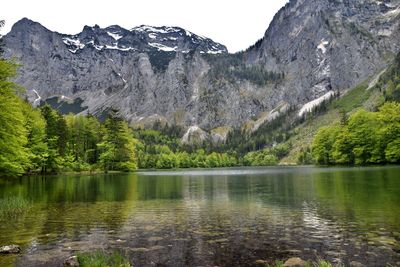 Scenic view of lake and mountains against sky